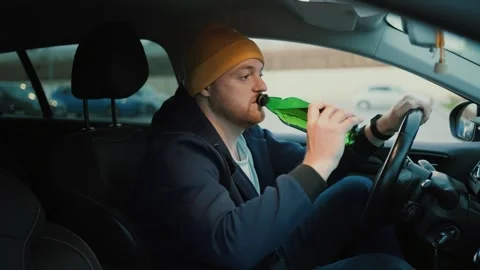 Serious man driver with beer bottle in hand Stock Footage 261506834