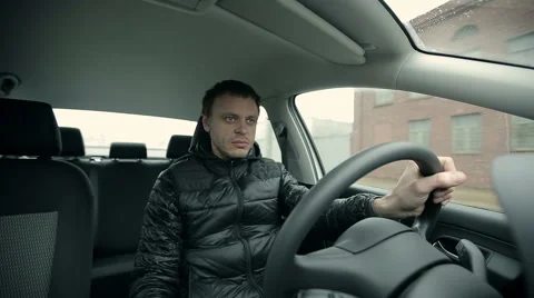 Serious man driving a car Stock Footage 47652496