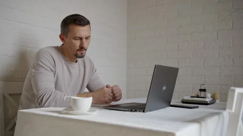Serious Man Gesturing During Video Conference at Home Table. Focused man si.. Video stock 331971374