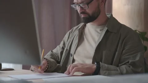 A serious man with glasses with a beard is developing a project. Video stock 137232529