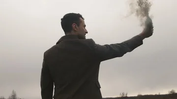 Serious man holding smoke bomb with black fume Stock Footage