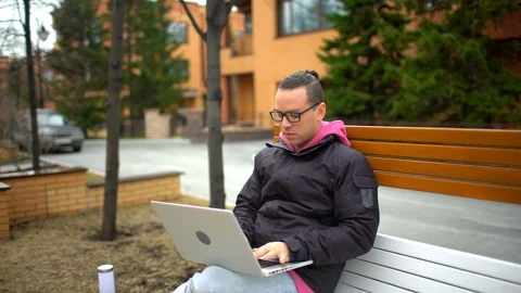 Serious man with laptop working. Hispanic Ethnicity Young Man using Laptop Stock Footage 89397110