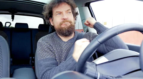 Serious man with long beard dancing like crazy driving car slow motion Stock Footage 61069316