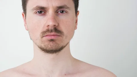 Serious man with mustache and beard on a white background. look into the camera Stock Footage 128731524