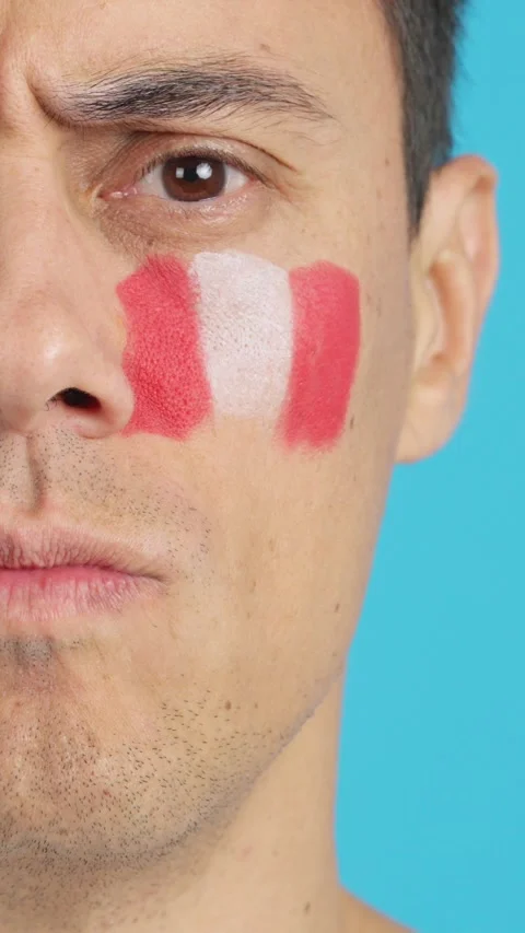 Serious man with a peruvian flag painted on the face Stock Footage 258235328
