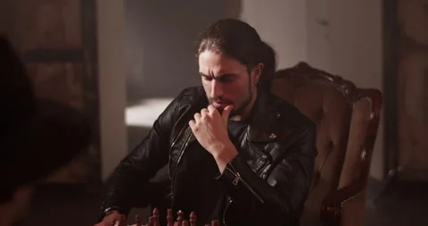 Serious man playing chess game in room Stock Footage 260562470
