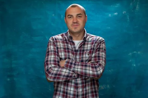 Serious man posing against blue background Stock Photos