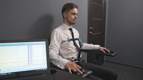 Serious man with pulse electrodes connected to polygraph Stock Footage 122627594