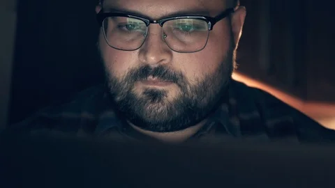 Serious man with reflection of laptop screen with website data in glasses Stock Footage 101131649