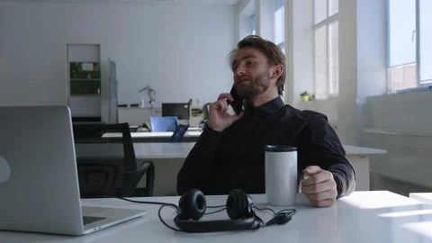 Serious man sits and talks on his smartphone Video stock 157803859