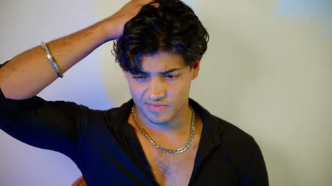 Serious man sits thinking with hand on head Stock Footage 305960071