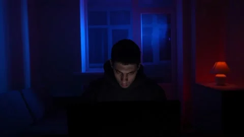 Serious Man Sits Working Laptop Home Night in Neon Lighting. Concept Remote Work Stock Footage 232032197