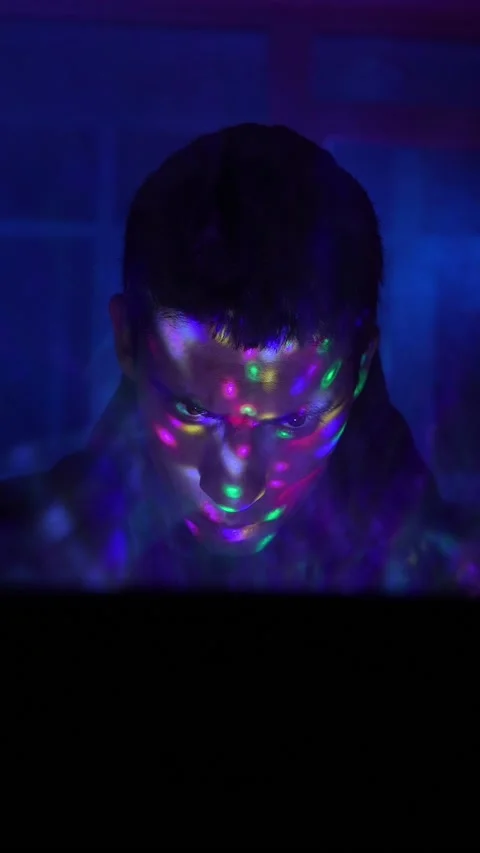 Serious Man Sits Working Laptop Home Night in Neon Lighting. Concept Remote Work Stock Footage 232977188