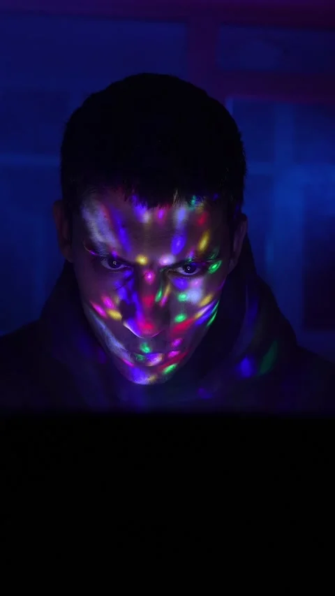 Serious Man Sits Working Laptop Home Night in Neon Lighting. Concept Remote Work Stock Footage 233185474