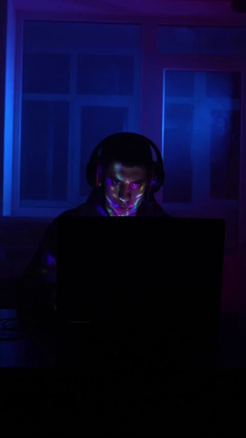 Serious Man Sits Working Laptop Home Night in Neon Lighting. Concept Remote Work Stock Footage 233185601