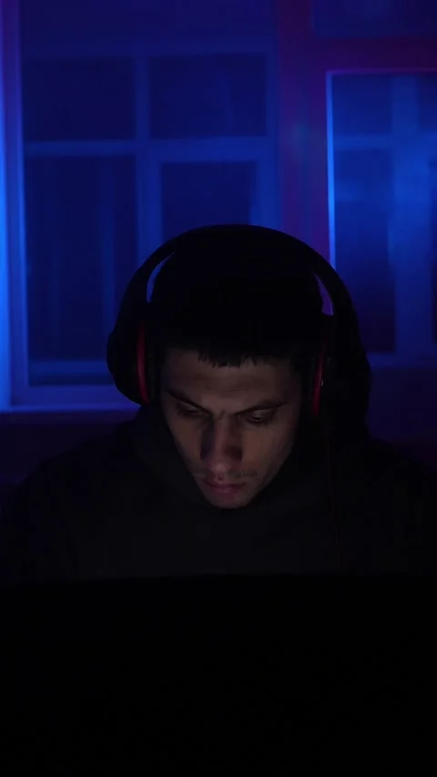 Serious Man Sits Working Laptop Home Night in Neon Lighting. Concept Remote Work Stock Footage 233628764