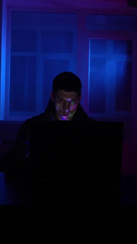 Serious Man Sits Working Laptop Home Night in Neon Lighting. Concept Remote Work Stock Footage 233826678