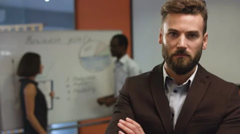 Serious man standing in his office , posing in a camera Stock Footage 68336061