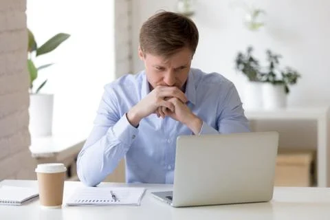 Serious man stuck with hard task, report calculations, problem solving. 스톡 사진