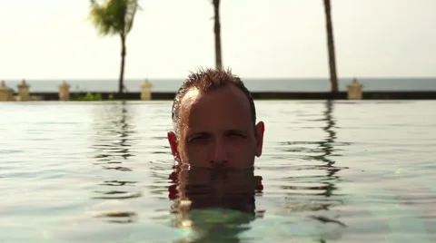 Serious man surfacing from water super slow motion 120fps HD Video stock 40742448