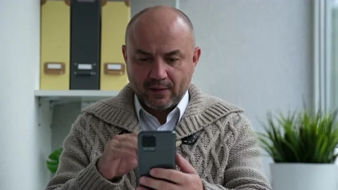 Serious man talking on video chat using smartphone. Video conference call on Stock Footage 162568247
