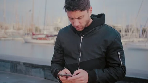 Serious man is texting or writing important news message or email on smartphone Stock Footage 101489462