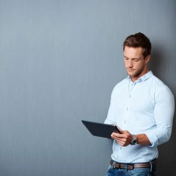 Serious man using digital tablet Stock Photos