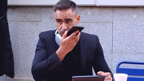 Serious Man Using Voice Command on Smartphone at Outdoor Cafe Video stock 301709333