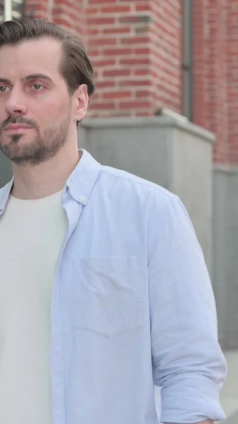 Serious Man Walking in Street, Side View, Vertical Video Video stock 339664702