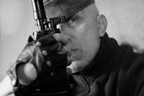 Serious man with weapon Фото