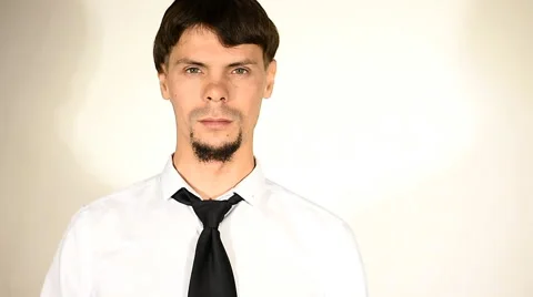 Serious man in white shirt eats pizza Stock Footage 67982722