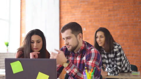 Serious man working at the computer. finds a suitable option on the Internet and Stock Footage 86646905
