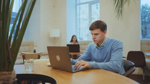 Serious man working on laptop in cafe Stock Footage 166499548