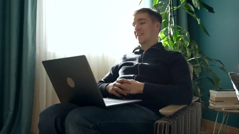Serious man working on laptop talking on video chat conference Stock Footage 243230929