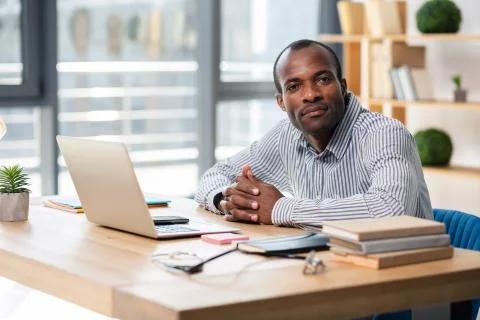 Serious manager looking straight at camera Stock Photos