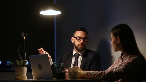 Serious manager teaching instructing intern late in office with computer 스톡 동영상 80723737