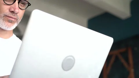 Serious mature man using his laptop while working in the office. Stock Footage 136534521