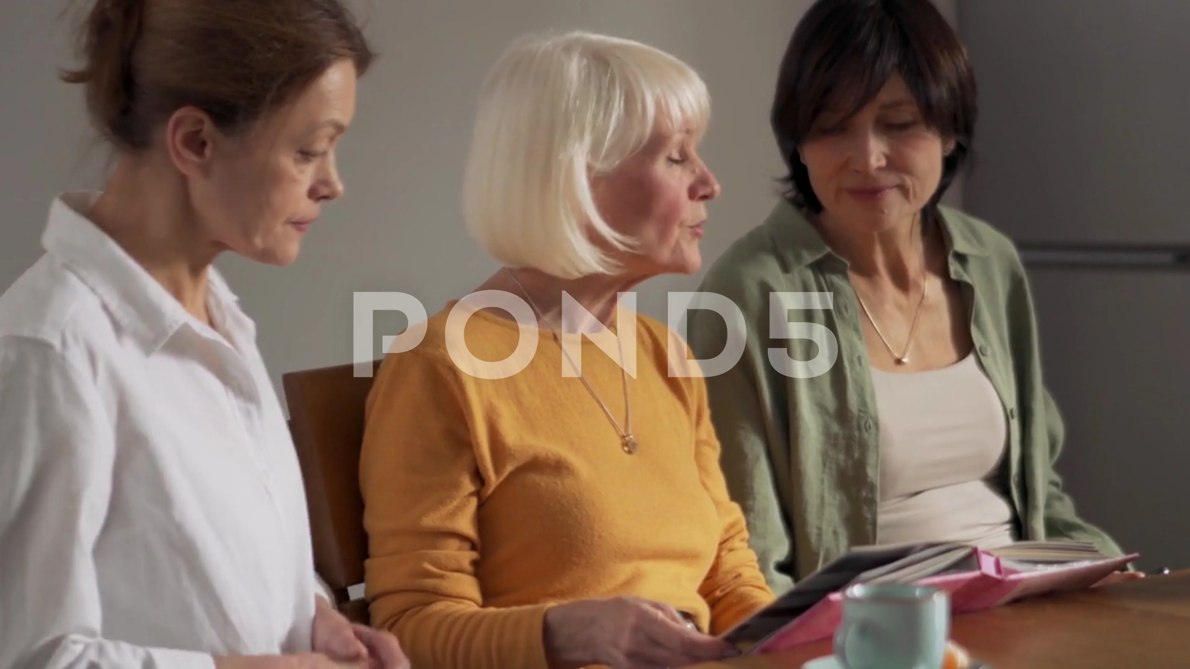 Serious mature women looking at old photos