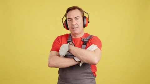Serious mature worker looking at camera in work uniform Видео 234858912