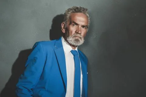 Serious Matured Businessman Leaning Against Wall Stock Photos