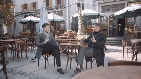 Serious men in suits sitting in a cafe Video stock 243826788