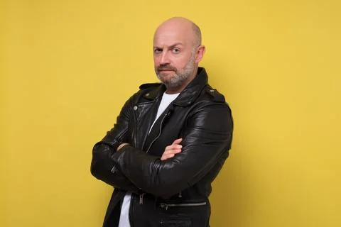 Serious middle aged man with folded arms and a serious expression Stock Photos