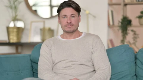 Serious Middle Aged Man Looking at the Camera at Home Video stock 142370588