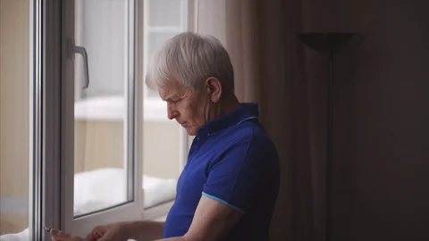 Serious middle-aged man putting on glasses and use smartphone 스톡 동영상 102043978