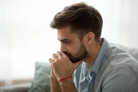Serious millennial man thinking of problem solution Stock Photos