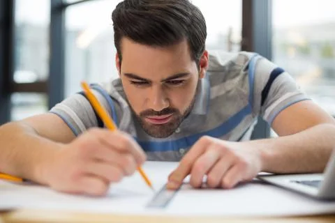 Serious nice man doing a drawing Stock Photos