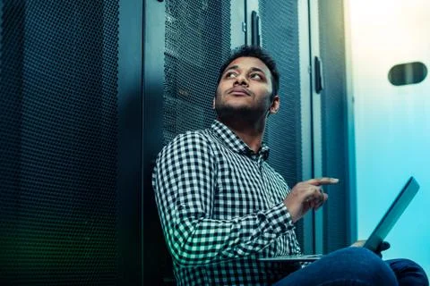 Serious nice man pressing a button on the laptop Stock Photos