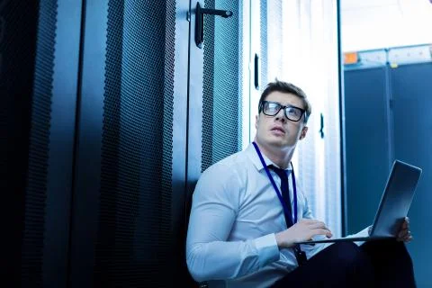 Serious operator working on his laptop Stock Photos