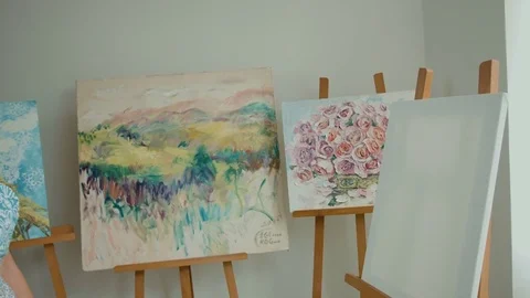Serious painter looking at canvas and thinking what to draw on it Stock Footage 74198020