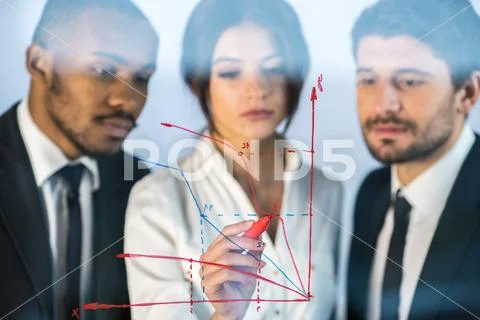 The serious people draw the graph at the virtual screen Stock Photos
